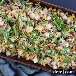 Chopped Fall Pasta Salad, showcasing vibrant ingredients like pasta, greens, bacon, apples, and cheese.