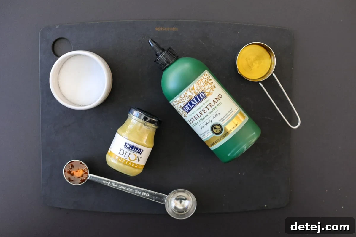 Ingredients for the apple cider Dijon vinaigrette, including olive oil, apple cider vinegar, honey, and Dijon mustard.
