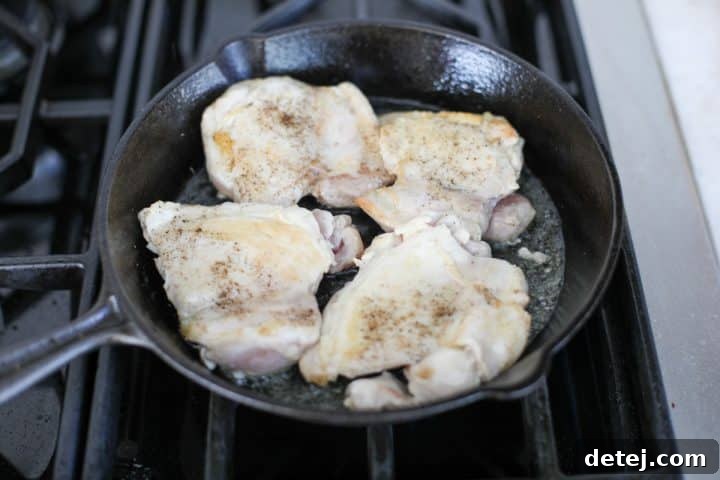 chicken searing in the pan.