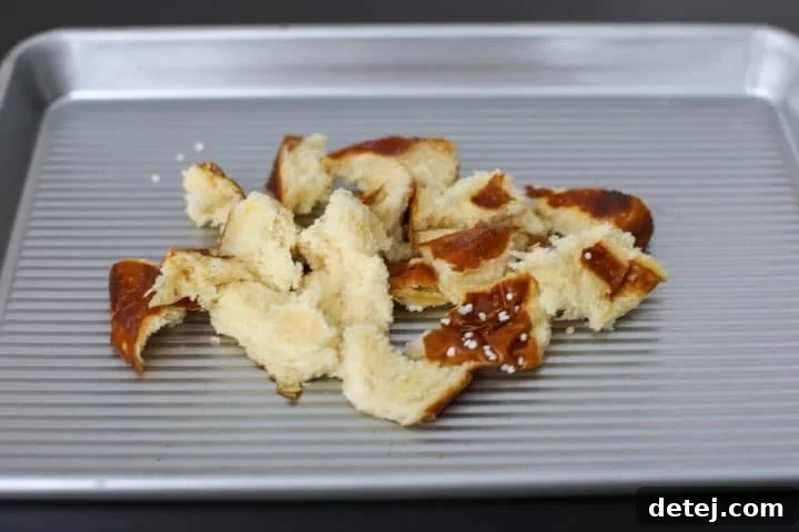 tor pretzel roll on a baking tray.