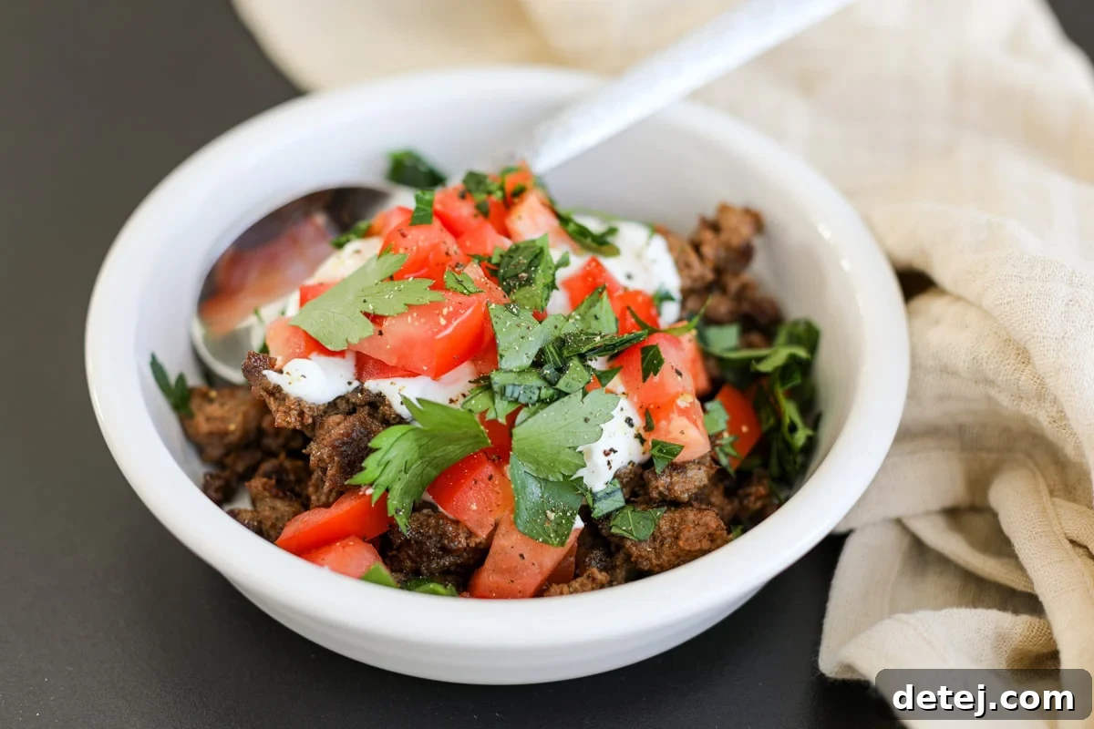 Effortless 20-Minute Turkish Beef Bowl 2 A vibrant Turkish Beef Bowl featuring spiced beef, Greek yogurt, fresh tomatoes, and parsley, ready to be enjoyed.