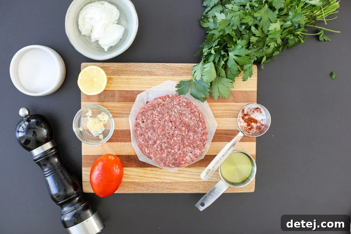 Effortless 20-Minute Turkish Beef Bowl 3 A selection of fresh ingredients laid out, including ground beef, spices, Greek yogurt, lemon, garlic, tomatoes, and parsley, ready for making Turkish Beef Bowls.