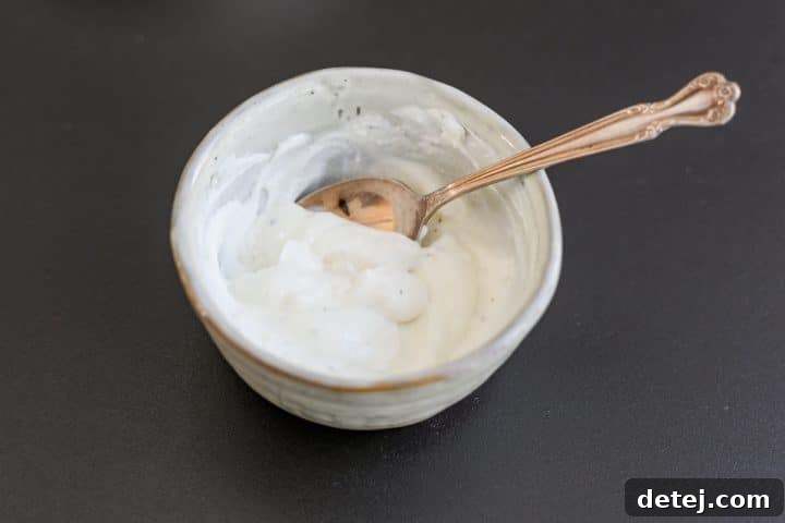 Effortless 20-Minute Turkish Beef Bowl 5 The Greek yogurt mixture, now fully combined, in a small bowl, showcasing its smooth and creamy texture.