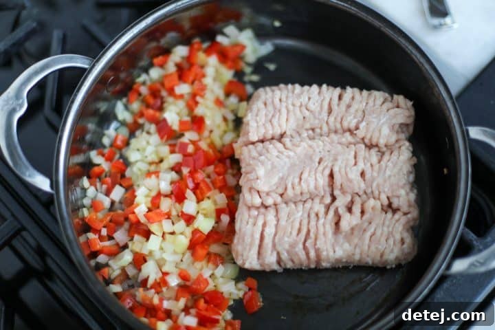 ground chicken and peppers in a pan.