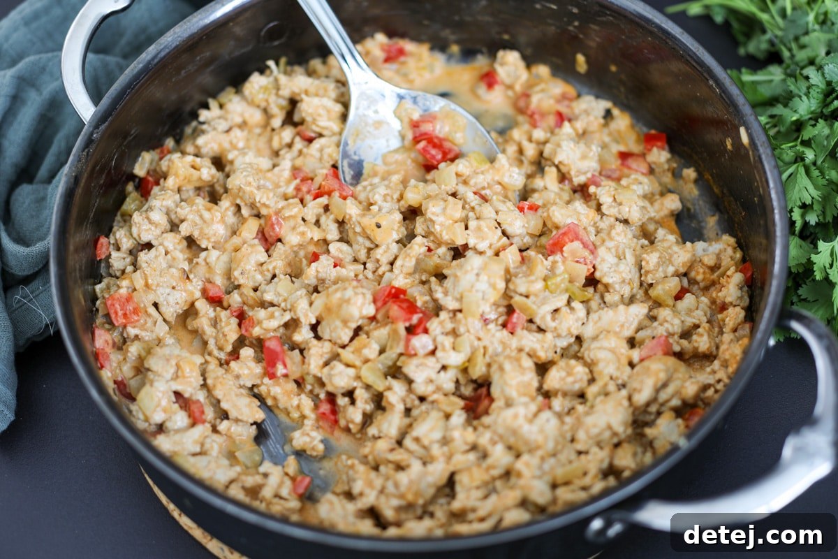 creamy ground chicken mixture in a pan.