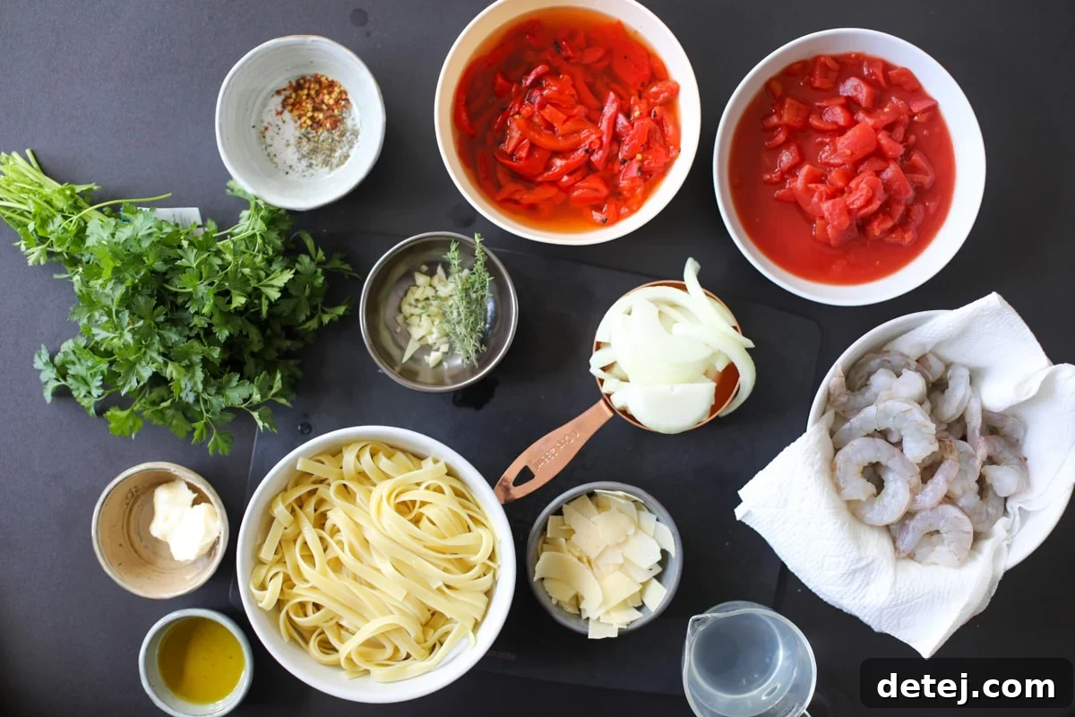 Smoky Red Pepper Shrimp Pasta 3 Ingredients for Shrimp Pasta with Roasted Red Pepper Sauce laid out on a wooden board, including fresh shrimp, linguine, onions, garlic, canned tomatoes, and roasted red peppers.