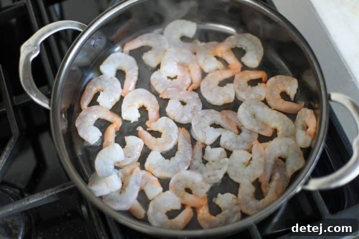 Smoky Red Pepper Shrimp Pasta 5 Shrimp cooking in a pan with hot oil.