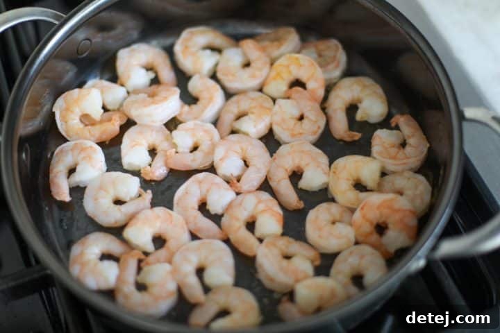 Smoky Red Pepper Shrimp Pasta 6 Cooked, sautéed shrimp in a pan, removed from the heat.