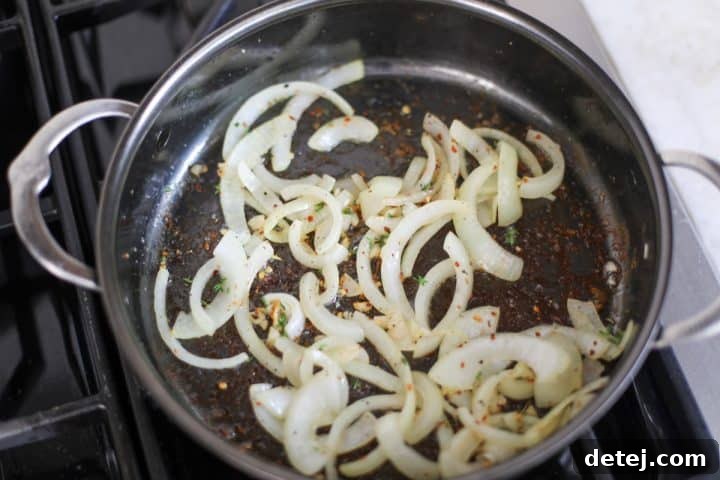 Smoky Red Pepper Shrimp Pasta 8 Onions, garlic, and spices cooking together in a pan with olive oil.