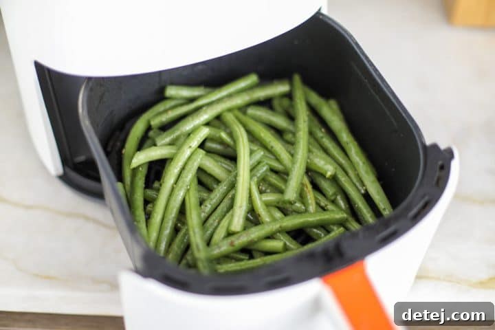 seasoned beans in the air fryer basket.