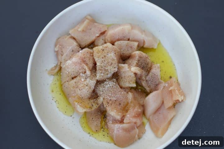 cubed chicken with oil, salt and pepper. 