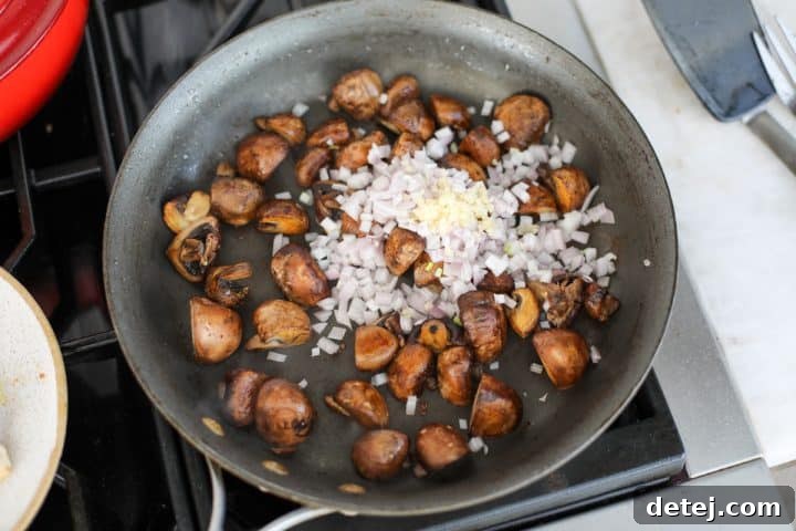 quartered mushrooms, shallots and garlic in a pan.