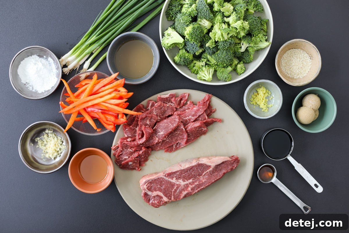 Ingredients for Beef and Broccoli stir-fry laid out on a wooden cutting board.