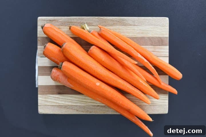 Peeled, whole carrots ready for slicing.