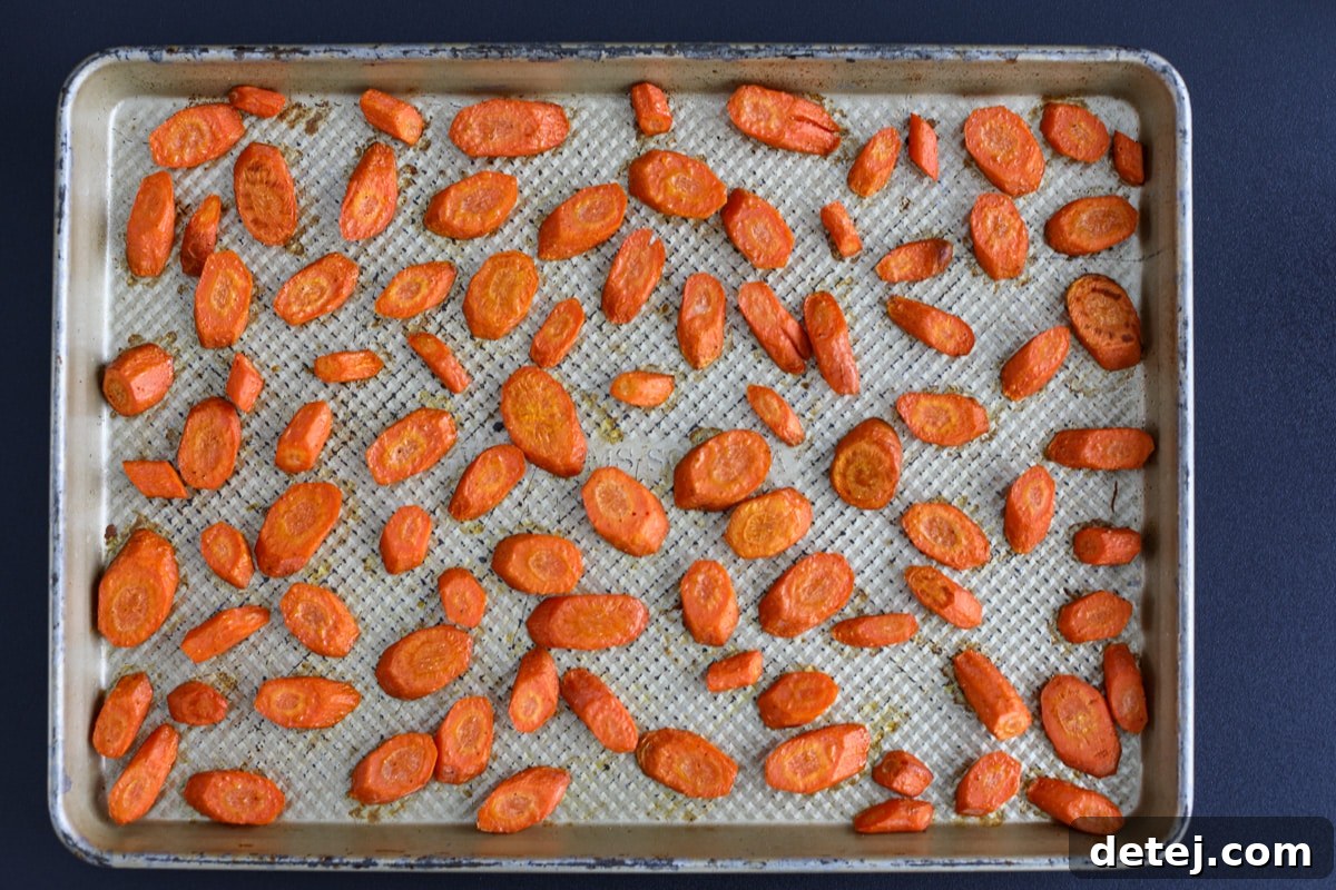 Freshly roasted carrots removed from the oven, ready for serving.