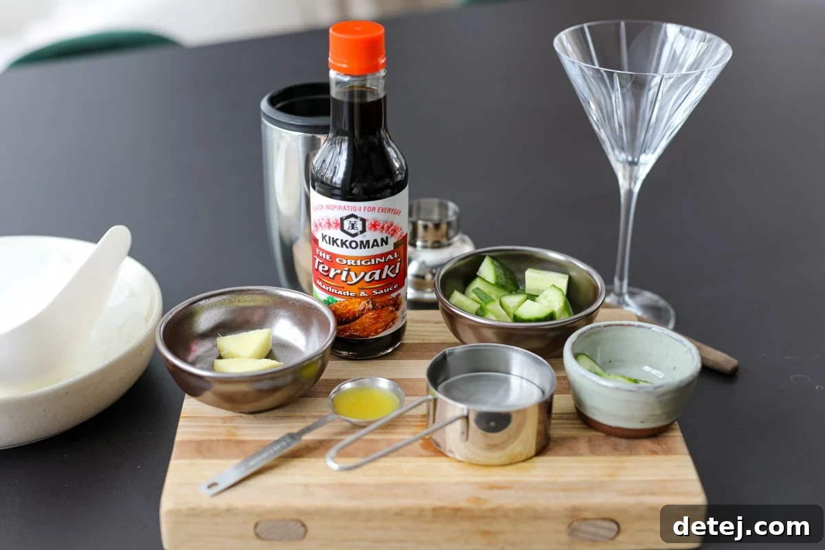 Umami Tini 3 A selection of fresh ingredients including English cucumber, ginger, Kikkoman Teriyaki Sauce, pineapple juice, and vodka, laid out for the Teriyaki Tini recipe.