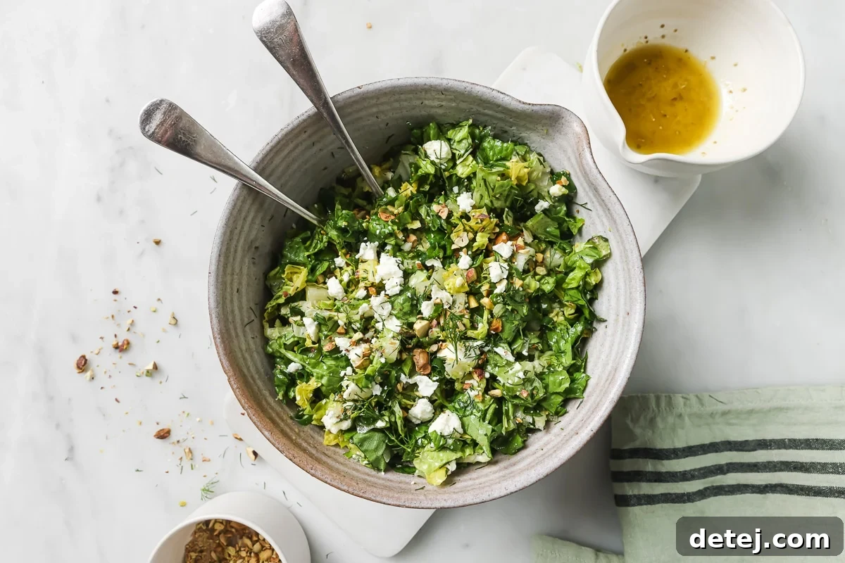 A large bowl filled with the colorful Chopped Greek Salad, showcasing the combination of ingredients before dressing.