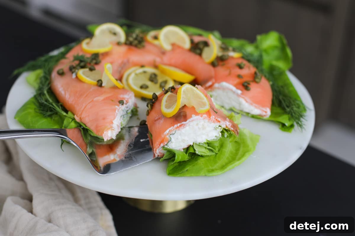 A perfectly sliced portion of the Smoked Salmon Ring, showing the creamy filling and salmon layers.