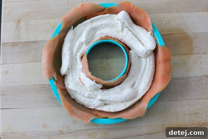 The donut mold, now lined with smoked salmon and filled with the creamy cream cheese mixture.