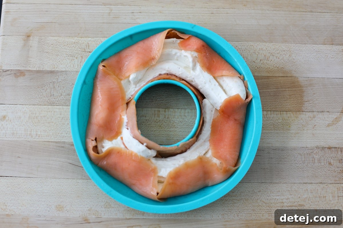 The smoked salmon edges neatly folded over the cream cheese filling, sealing the ring.