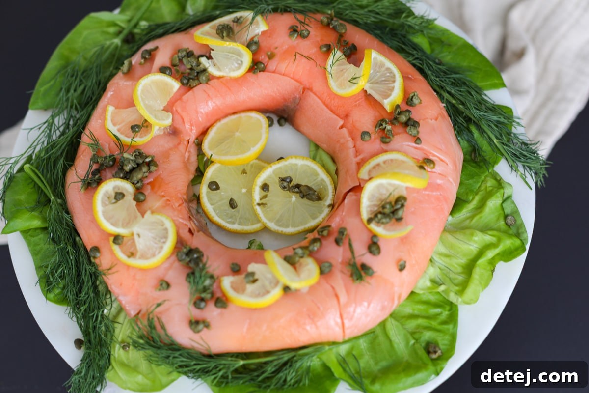 The final presentation of the Smoked Salmon Ring, ready to be served, showcasing its vibrant garnishes.