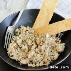 A bowl of Smashed Bean Tuna Salad, garnished and ready to eat.