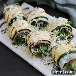 grilled zucchini roll ups on a plate.