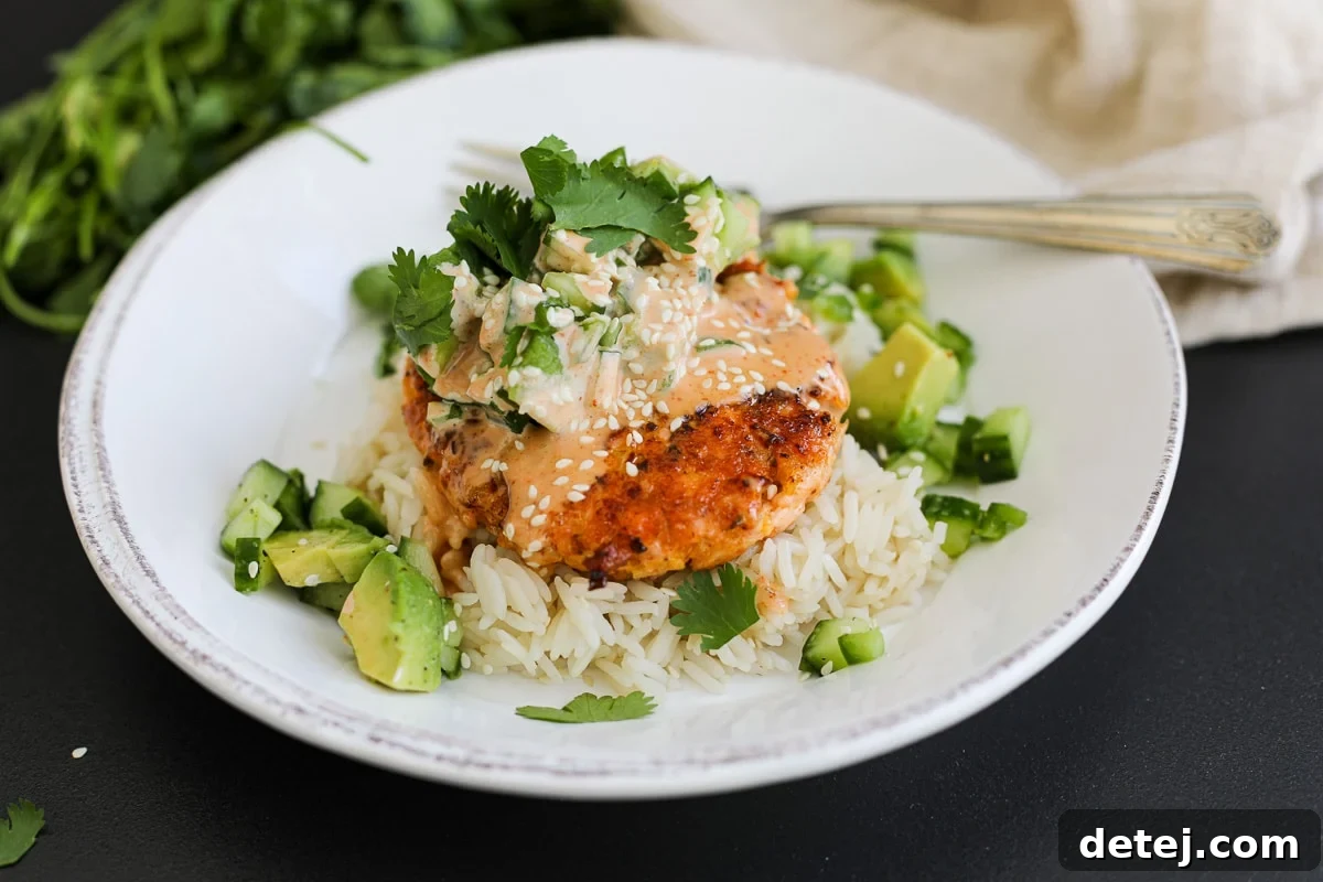 Delicious and vibrant Spicy Salmon Burgers served in bowls with fresh toppings.