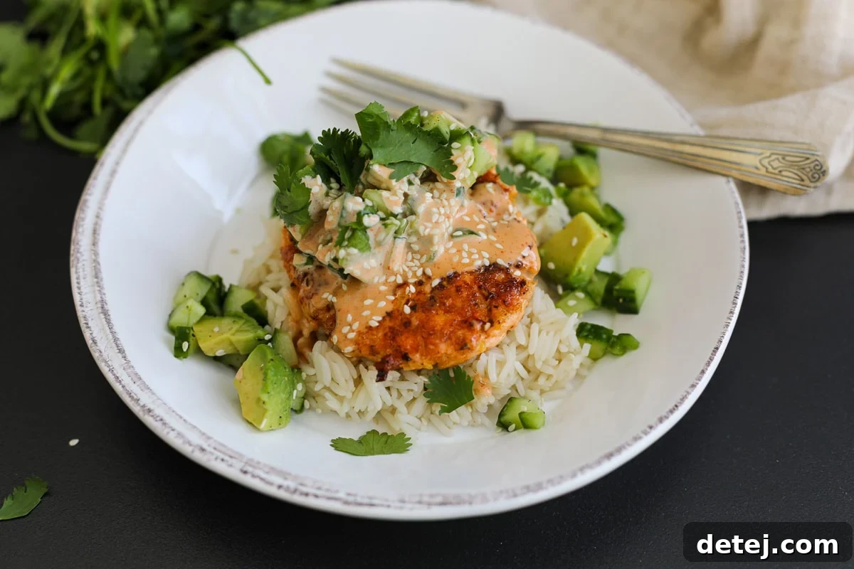 Beautifully arranged spicy salmon burger bowls, showcasing the vibrant colors of the ingredients.