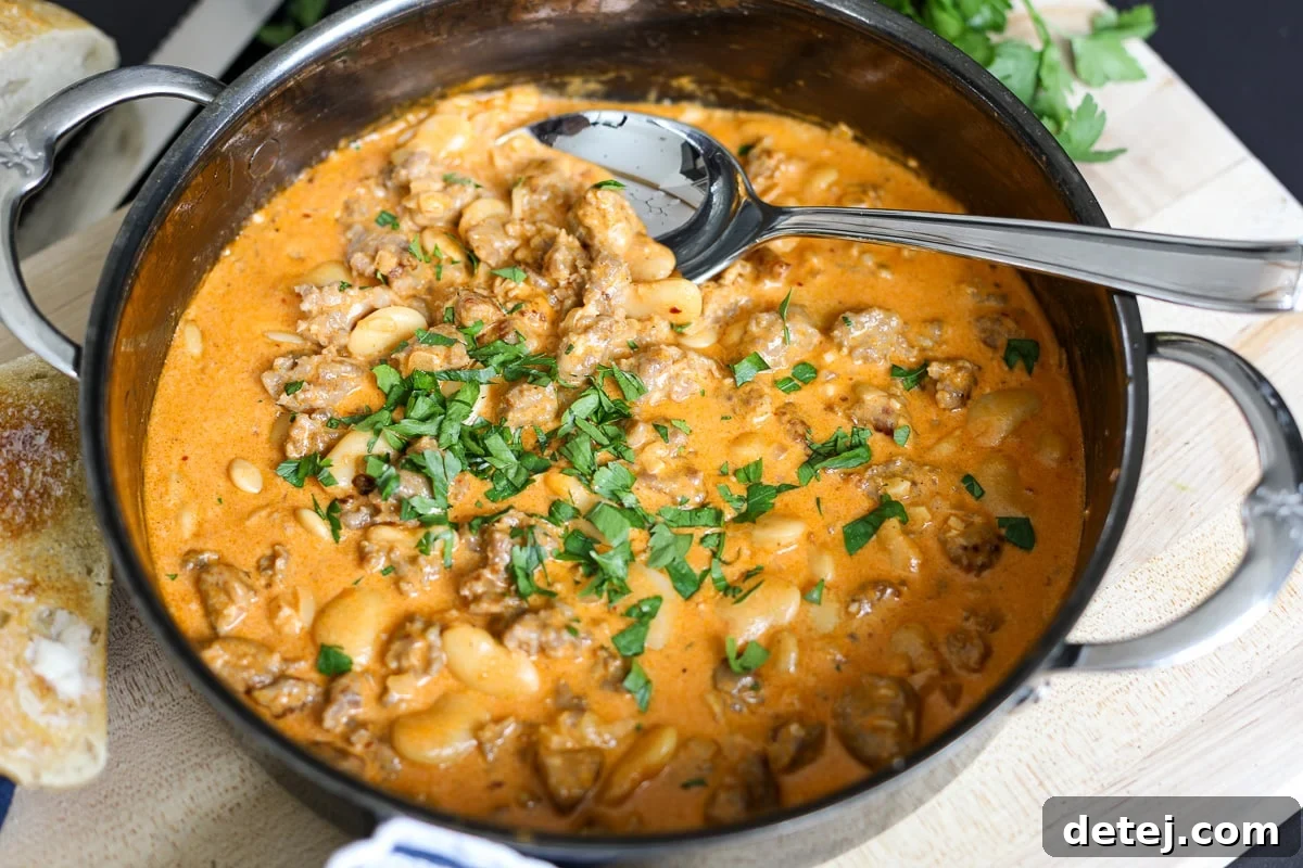 The completed one-pan butter bean and sausage dip, warm and inviting, ready to be served directly from the skillet.