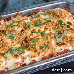 Tomato pie dip appetizer fully dressed with panko and basil.