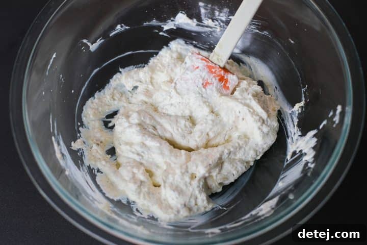 A bowl of cheese blend with spices thoroughly mixed together.
