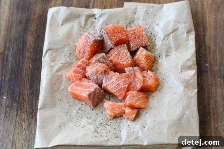 cubed salmon seasoned with salt and pepper.