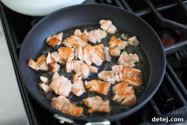 smashed salmon searing in a pan.