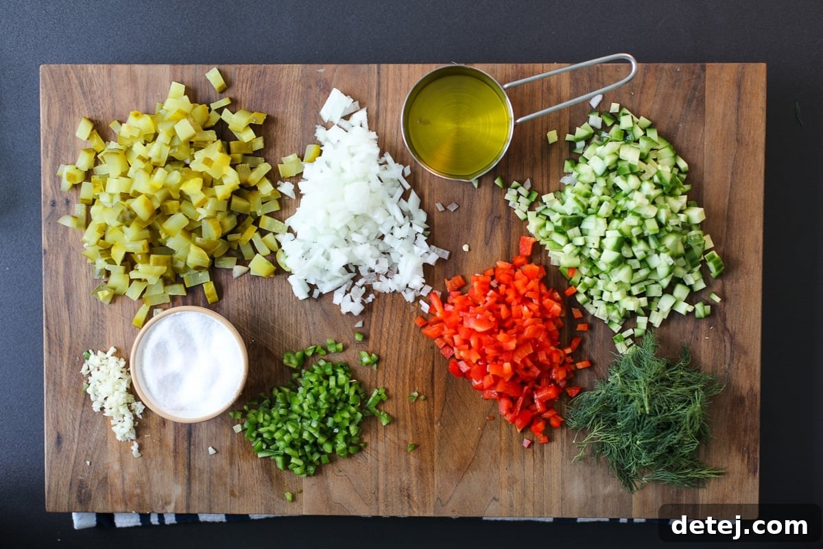 Dill-icious Salsa 3 Fresh ingredients laid out for making pickle de gallo, including pickles, cucumber, bell pepper, and onion.