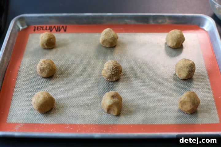 Cookie dough balls on a baking tray, ready for the oven.