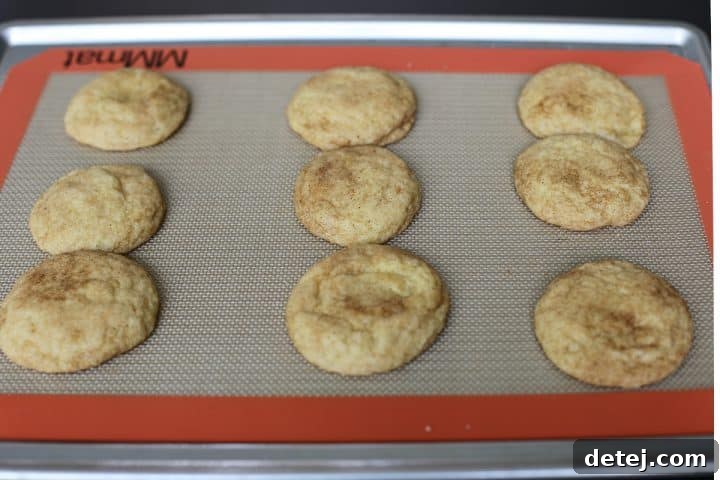 Freshly baked cookies with crispy edges on a tray.