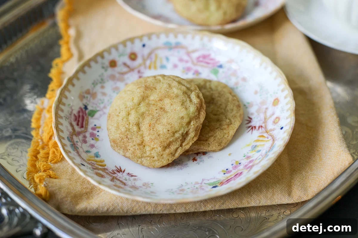 Two orange spiced cookies on a white plate, ready to be enjoyed.