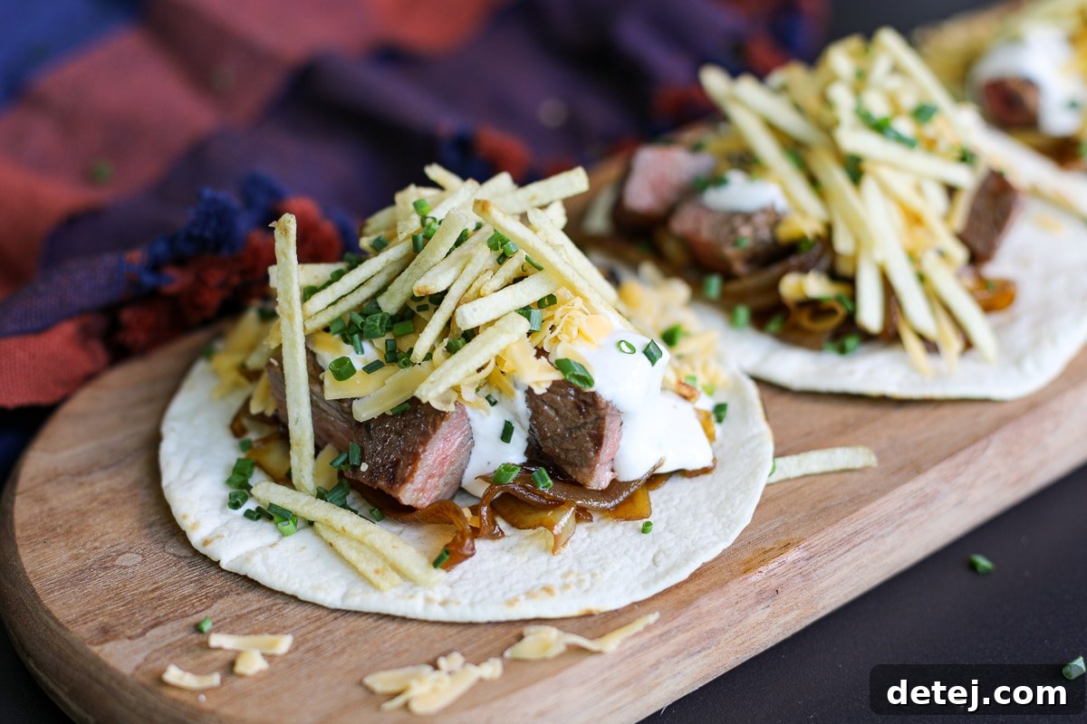 steak taco with caramelized onions, cheddar cheese and potato sticks.