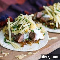 steak taco with caramelized onions, cheddar cheese and potato sticks.