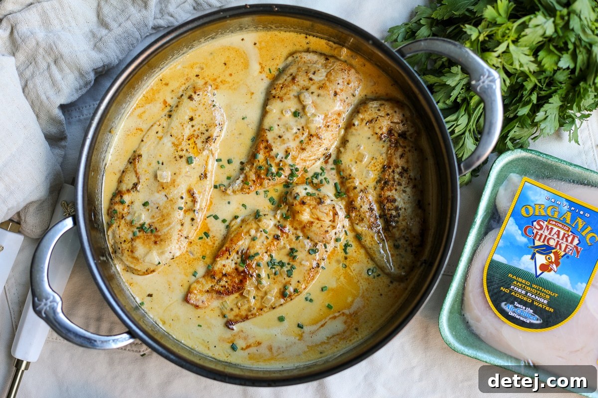 Finished blackened chicken dish with creamy mustard sauce, served alongside Smart Chicken packaging.
