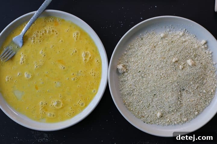 Agile Chicken Cutlets 4 Breading station set up with whisked eggs and mixed breadcrumbs.