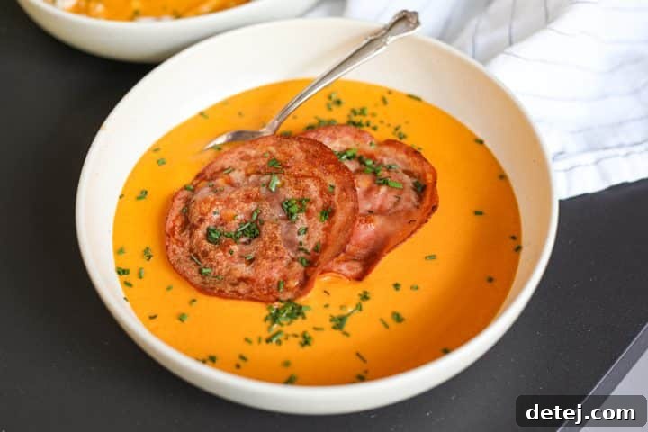 creamy vegetable soup in a bowl with a spoon.