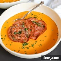 creamy vegetable soup, garnished with herbs.