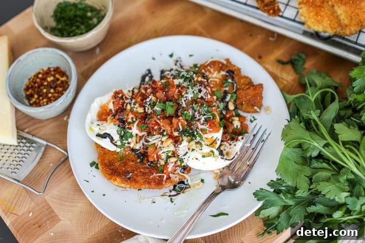 Close-up of a perfectly fried, golden-brown chicken cutlet, showcasing its crispy texture.