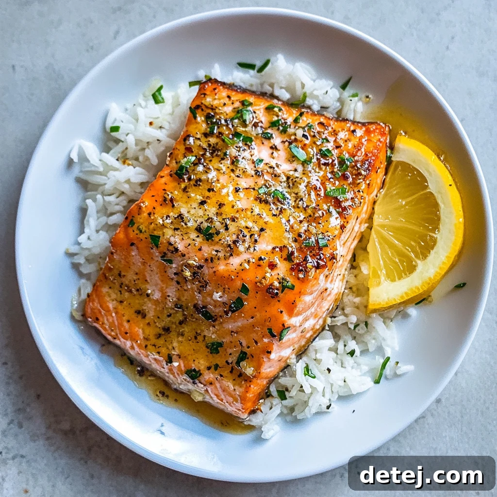 Baked Lemon Garlic Salmon on a plate with greens