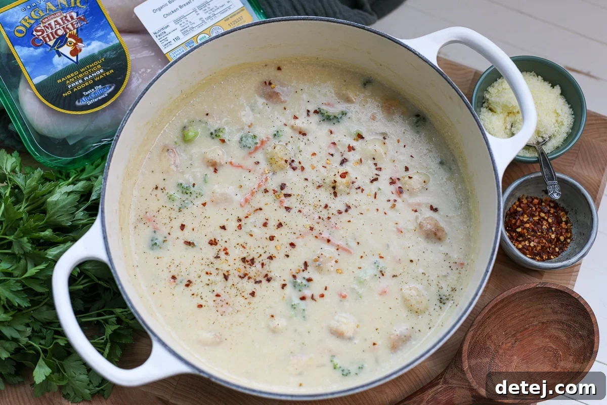 A large pot filled with healthy broccoli cheddar chicken soup, ready to be served.