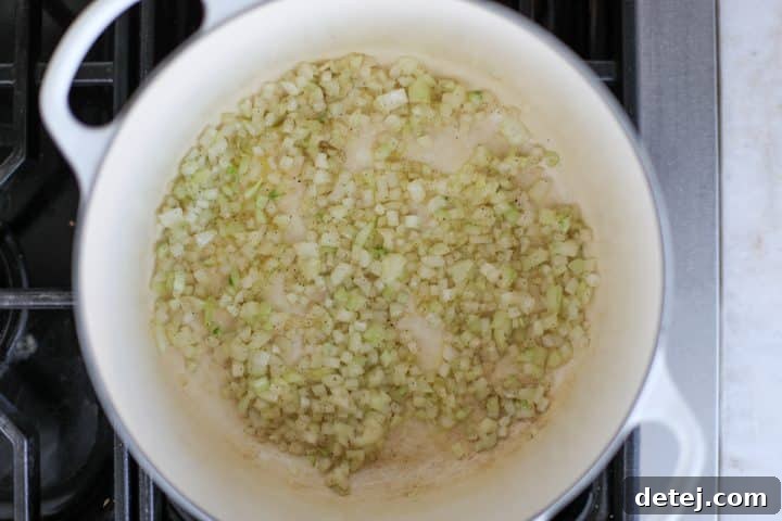 Diced onions sautéing in a soup pot.