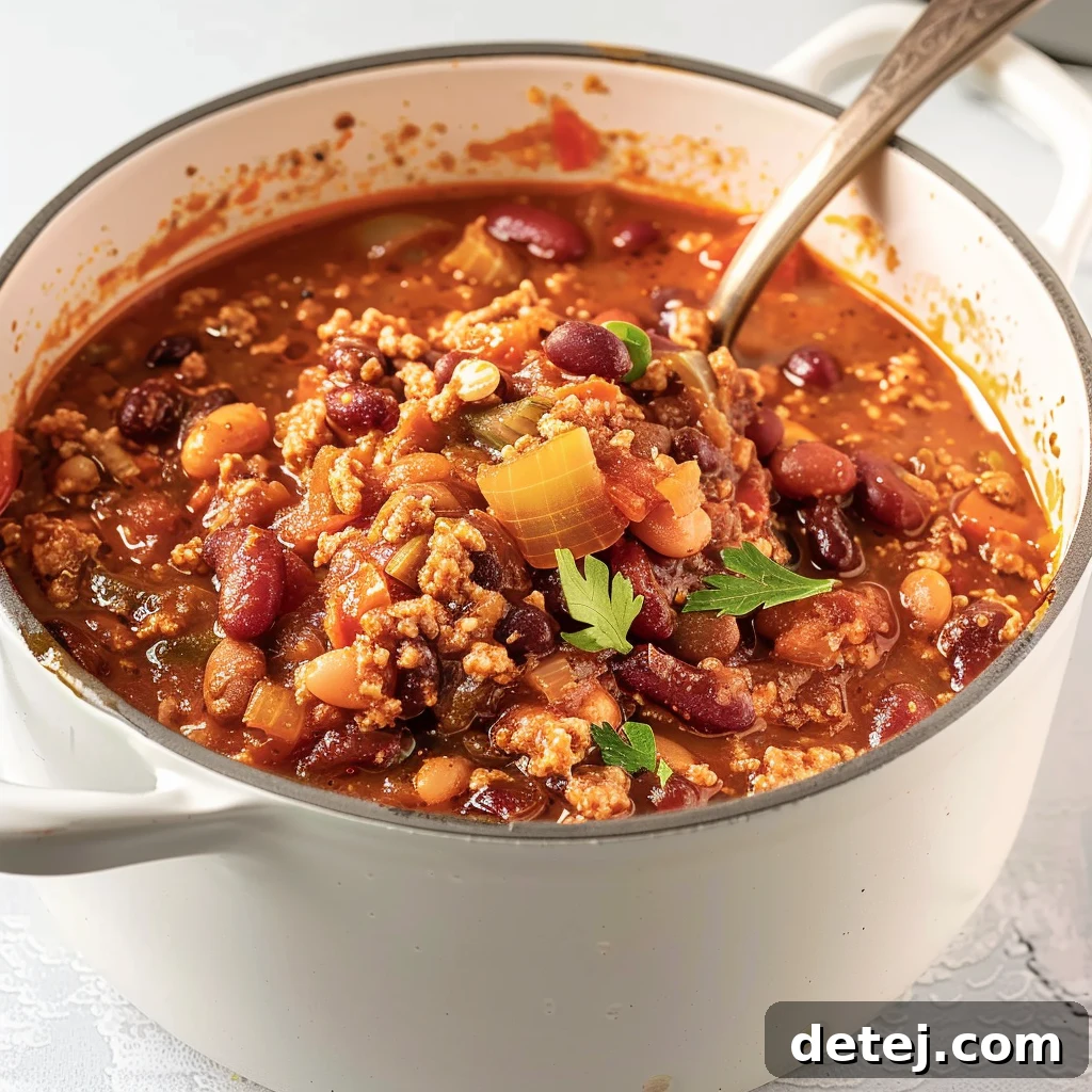 Simple Lean Turkey Chili 2 A vibrant bowl of healthy turkey chili, garnished with fresh herbs and a dollop of sour cream.
