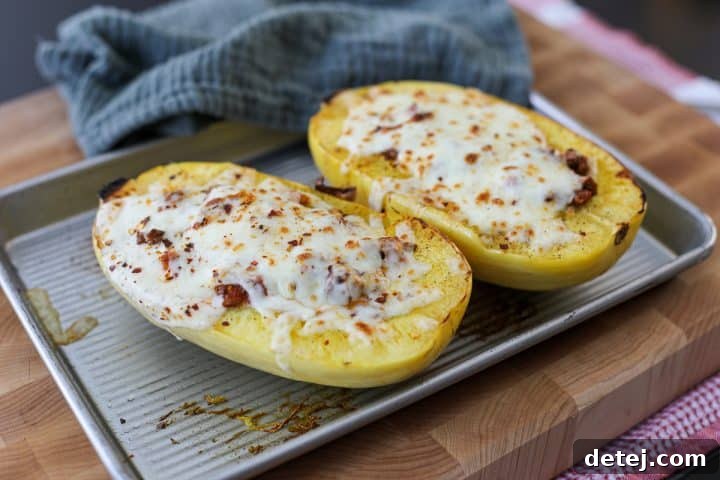 A perfectly broiled spaghetti squash boat, topped with golden, bubbly melted cheese.